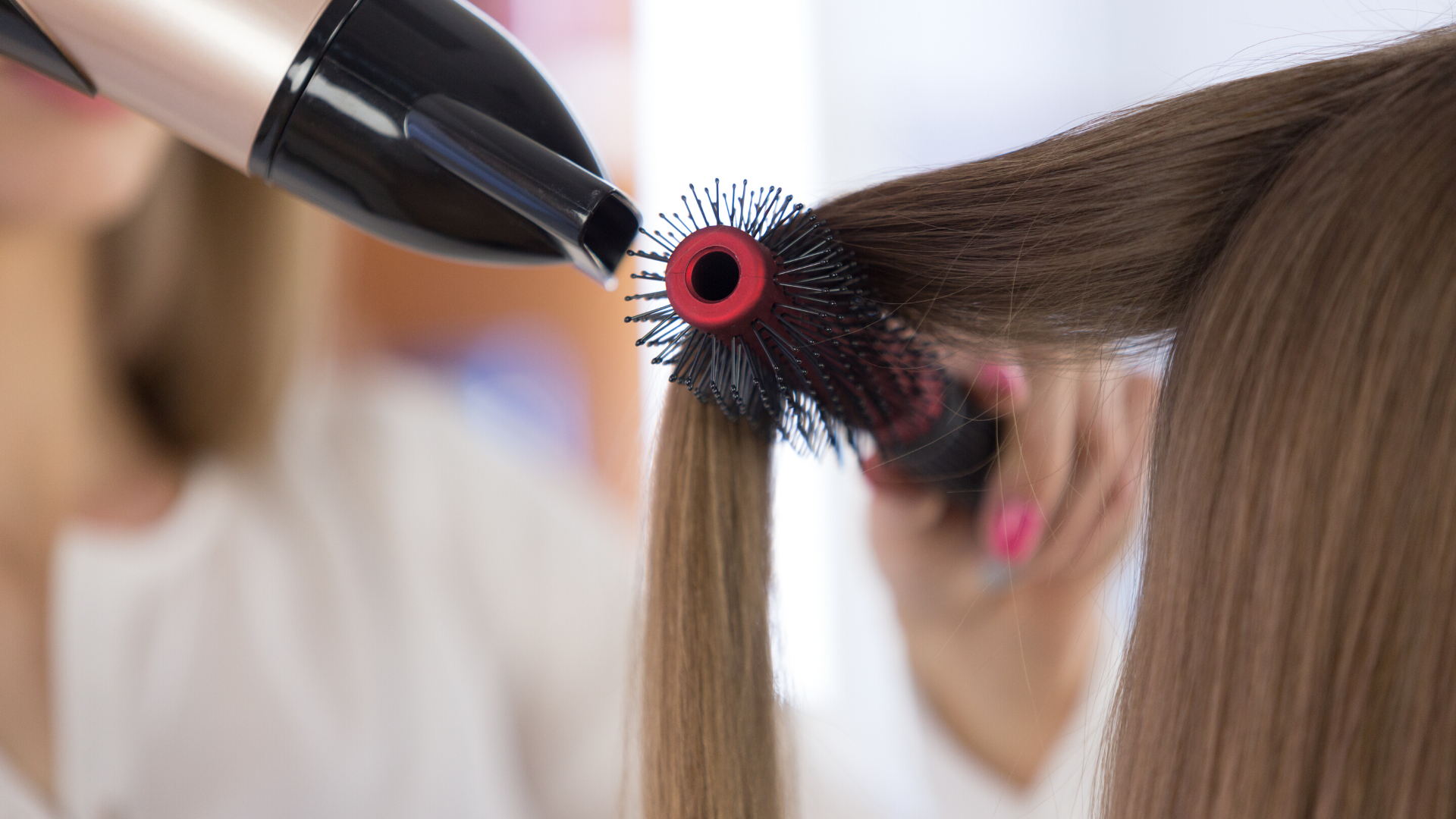 hairdresser blow drying hair